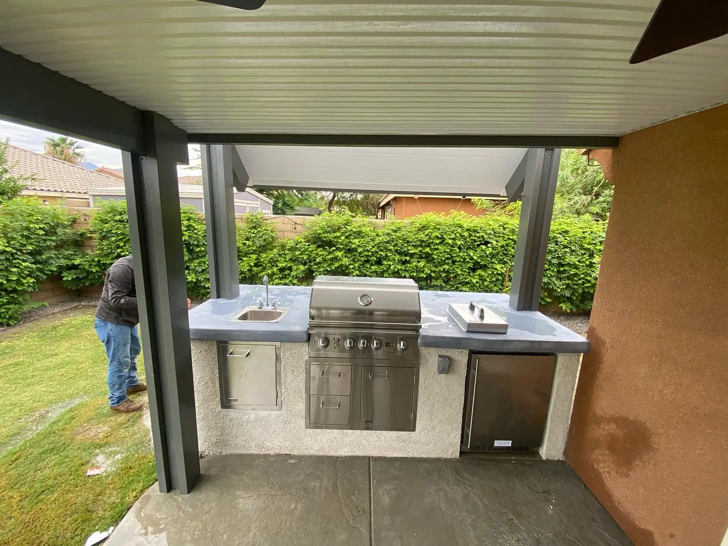 Outdoor kitchen island under a patio cover