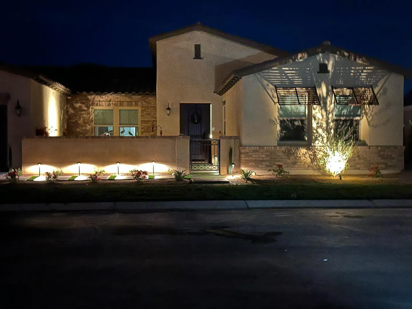 Warm uplighting on a home facade at night