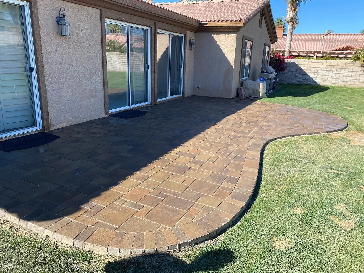 Multi-tone paver patio with turf border