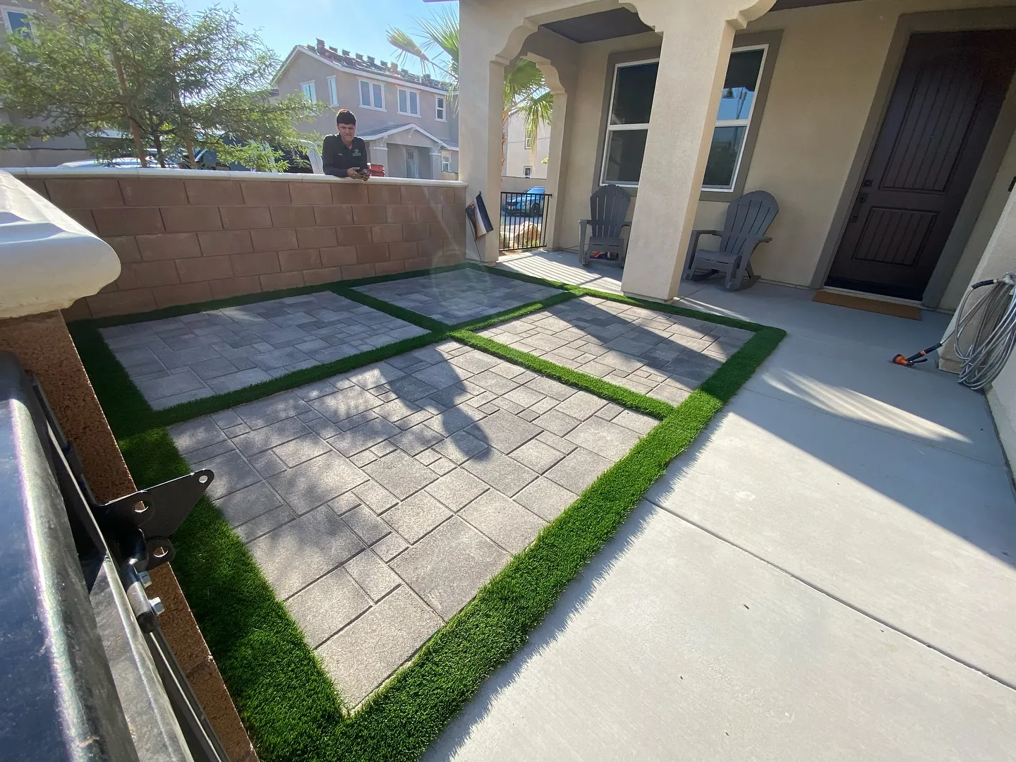 Paver squares set into turf in a side yard