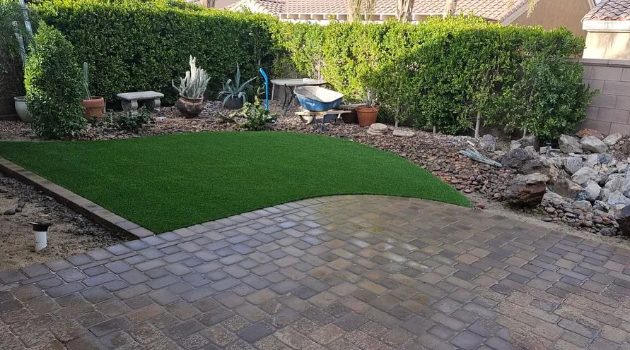 Paver walkway winding through a garden