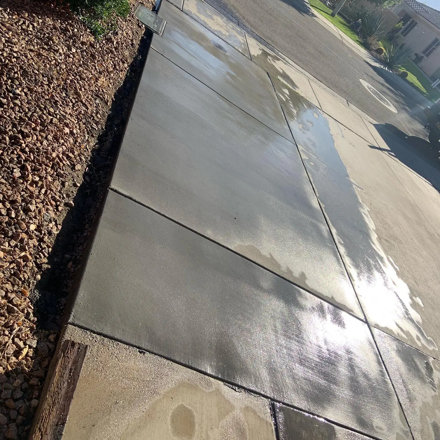 Concrete slab bordered by decorative rock