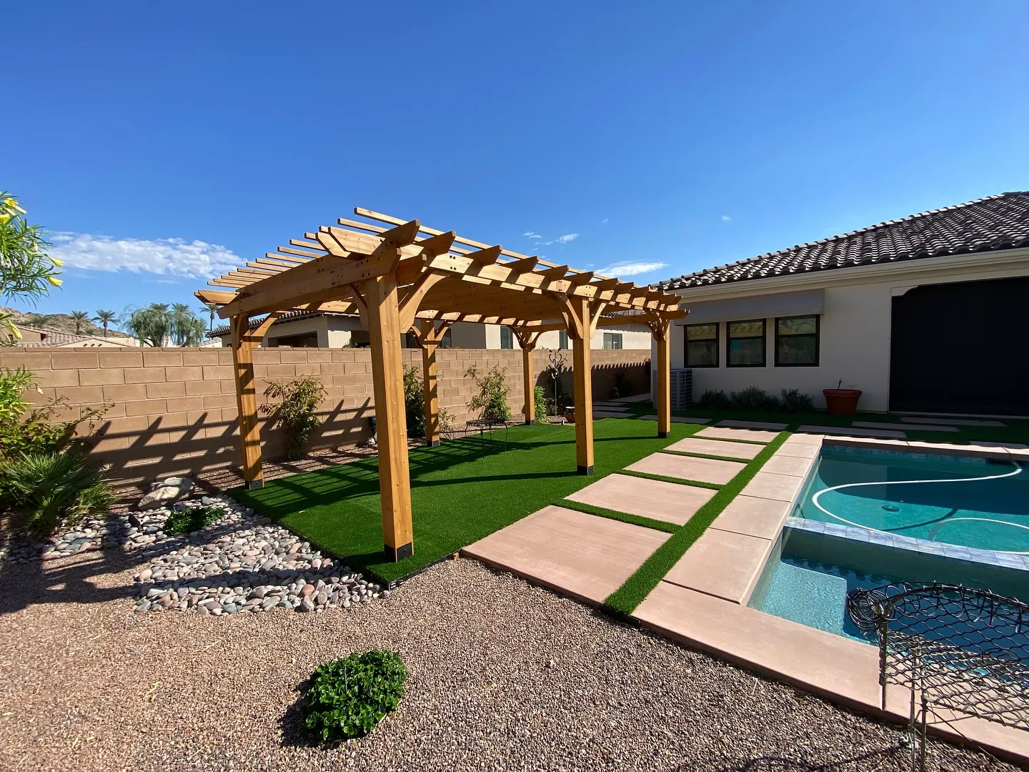 Wood pergola beside a pool with mountain views