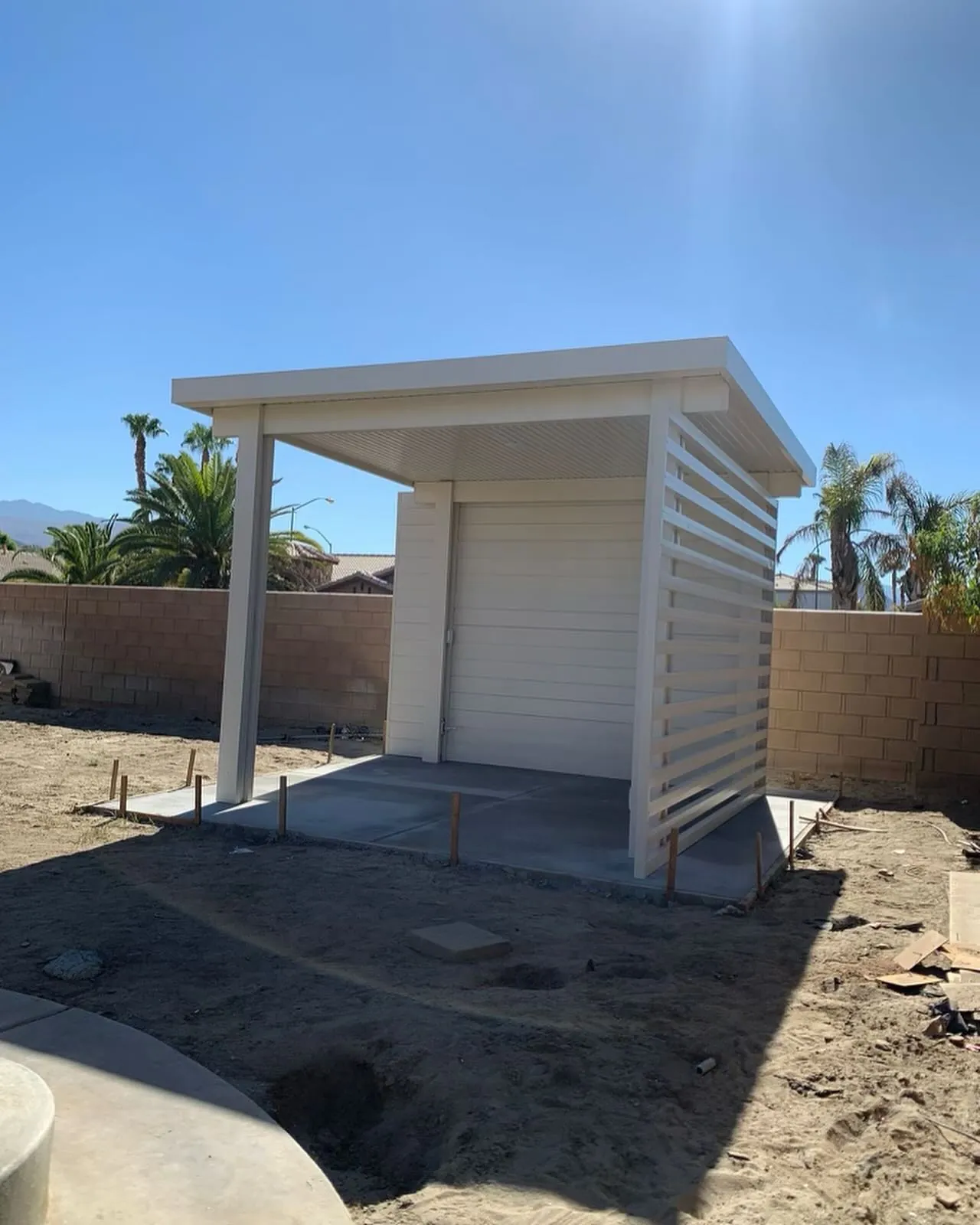 Freestanding white slatted shade structure