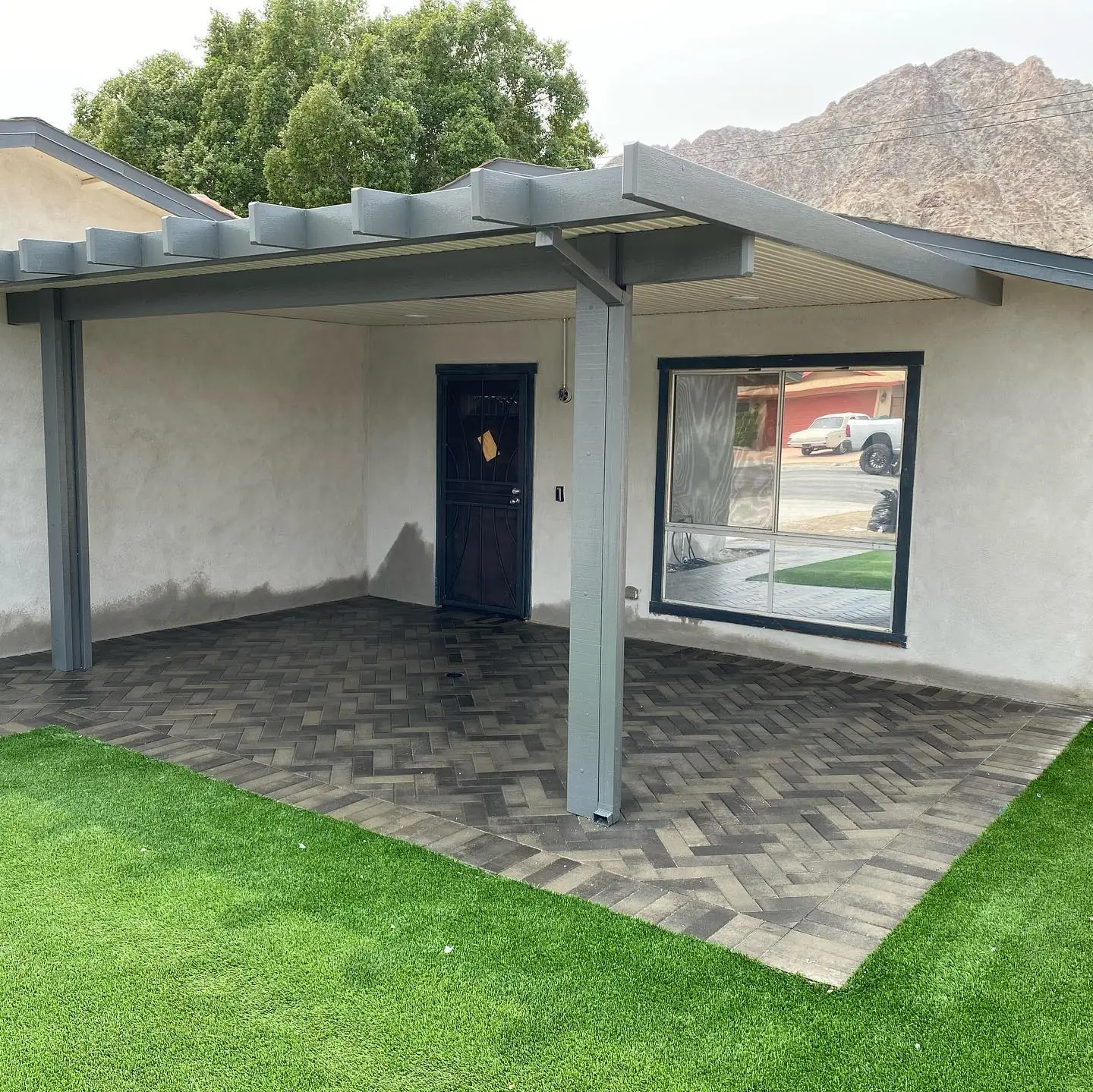 Solid-roof patio cover over a turf yard